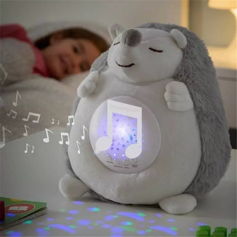 Petite fille souriante dans son lit, écoutant avec bonheur la musique de la veilleuse hérisson spicy, démontrant le plaisir et le confort que cette veilleuse musicale apporte aux enfants au coucher.